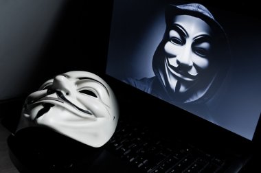 Vendetta mask on computer . This mask is a well-known symbol for the online hacktivist group Anonymous.