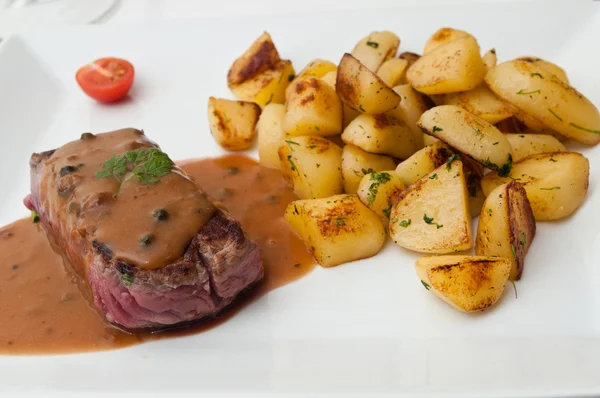 Steak grilled with pepper sauce and potatoes — Stock Photo, Image