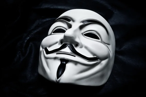 Paris - Frankreich - 18. Januar 2015 - Vendetta-Maske auf schwarzem Hintergrund. Diese Maske ist ein bekanntes Symbol für die Online-Hacktivistengruppe Anonymous — Stockfoto