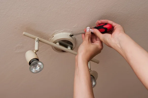 Woman changing a Light Bulb — Stock Photo, Image