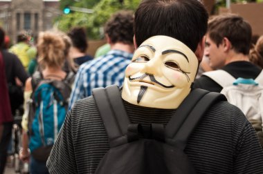 STRASBOURG - France - 23 May 2015 - people with anonymous mask during the demonstration against Monsanto and the transatlantique treated for the production of GMO in Europe - clipart