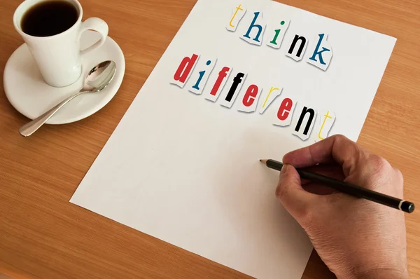 Concept office cup of coffee and white page and word think different — Stock Photo, Image