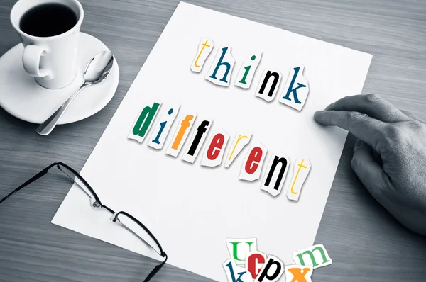 Concept office cup of coffee and word think different on white page — Stock Photo, Image