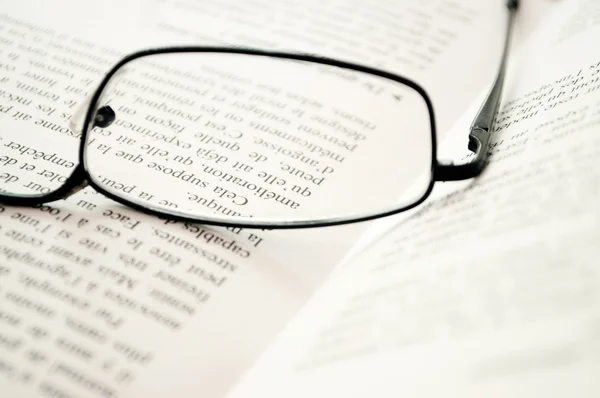 Glasses on a book closeup Royalty Free Stock Images