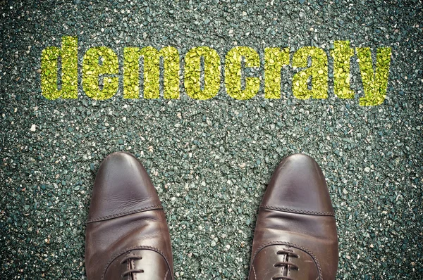 Concept signage on the road with shoes and word "démocratie" — Stock Photo, Image