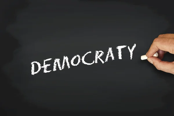 Írás krétával táblára - democraty koncepció — Stock Fotó