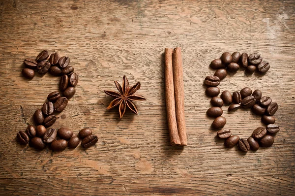 Happy new year card 2016 with coffee beans,  anise and cinnamon on wooden background — Stock Photo, Image