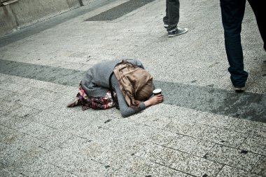 Zavallı kadın Paris sokakta diz çökmüş