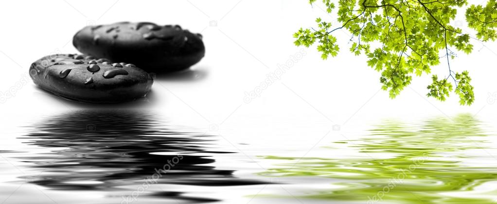 raindrops on black pebbles in border water