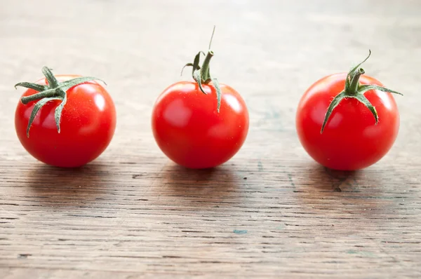 Tomates cereja no fundo de madeira — Fotografia de Stock