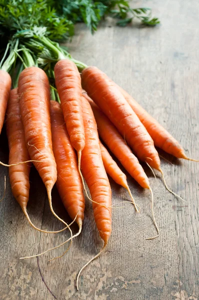 Group of Fresh Carrots on wooden background — Stock Photo, Image