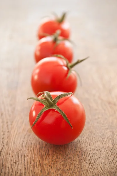 stock image cherry tomatoes on wooden background