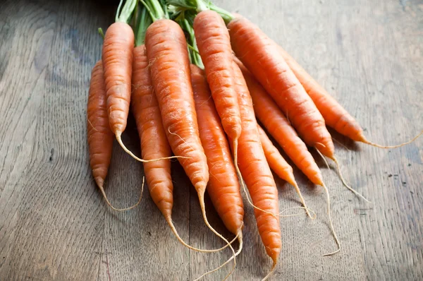 group of Fresh Carrots on wooden background