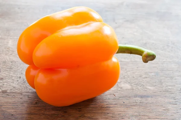 Orange  pepper on wooden background — Stock Photo, Image