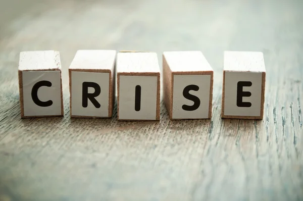 Concept word forming with  cube on wooden desk background - crise (crisis in french) — Stock Photo, Image