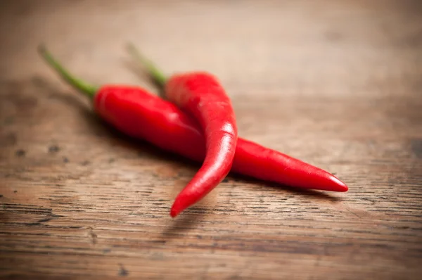 Red hot peppers on wooden background Stock Picture