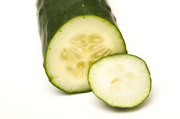 Big sliced pickle on white background — Stock fotografie