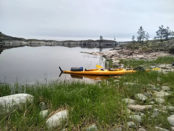 Orange canoe on the shore of lake Ladoga — Stock Photo, Image