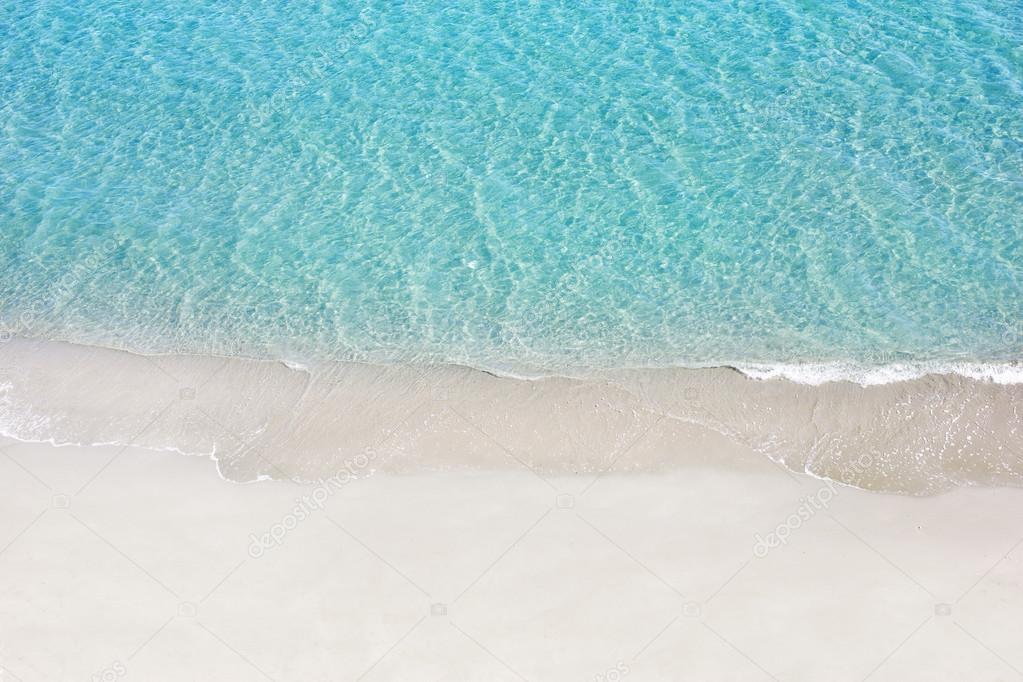 Beautiful white sand beach and tropical turquoise blue sea. View from above