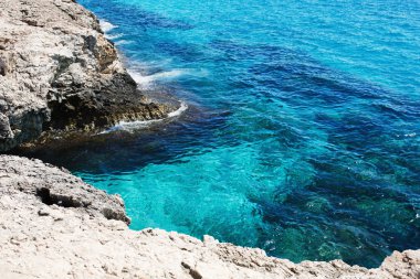 Transparent sea water. Rocky coast. Beautiful lagoon on Cyprus.