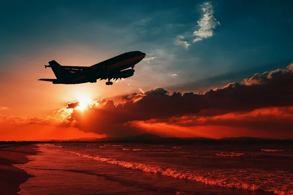 Airplane flying above tropical sea