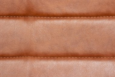 Sandalyenin deri döşemesinin arka planı yakın plandadır. Deri döşeme dokusu