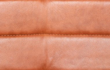 Sandalyenin deri döşemesinin arka planı yakın plandadır. Deri döşeme dokusu