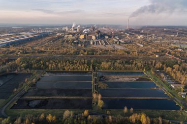 Endüstriyel çelik fabrikası, demir işi. Metalürjik bitki. Çelik fabrikası. Avrupa, Polonya, Dabrowa Gornicza 'da ağır sanayi. Bacalardan gelen hava kirliliği. Ekoloji ve çevre. Hava aracı fotoğrafı. 