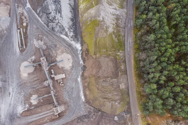 Sand pit quarry with big excavator, digger. Heavy machinery industry in Europe, Poland. Ecology and environmental. Aerial drone photo View