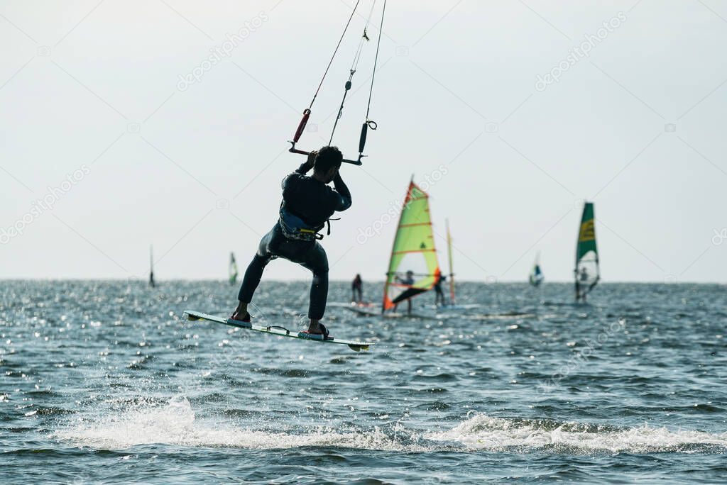 Kiteboard or kitesurfing tricks. Summer sport learning how to kitesurf. Kite surfing on Puck bay in Jastarnia, Poland, Europe