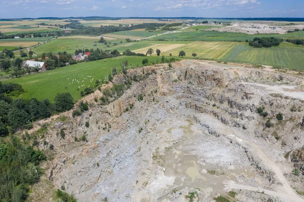 The Gneiss Mine, opencast mine in the countryside in Poland. Mine in a villae from drone aerial drone photo view.