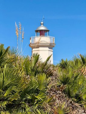 Capo Zafferano Italian coastal promontory and lighthouse by the Tyrrhenian Sea in Bagheria, Sicily Italy with rugged cliffs lush Mediterranean flora crystal clear water.