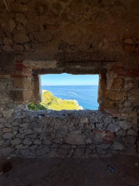 Capo Zafferano Italian coastal promontory and lighthouse by the Tyrrhenian Sea in Bagheria, Sicily Italy with rugged cliffs lush Mediterranean flora crystal clear water.
