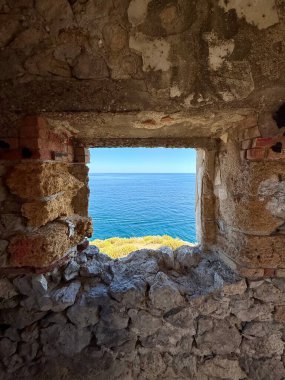 Capo Zafferano Italian coastal promontory and lighthouse by the Tyrrhenian Sea in Bagheria, Sicily Italy with rugged cliffs lush Mediterranean flora crystal clear water.