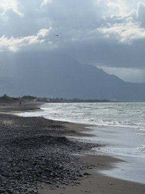 Campofelice di Roccella, a charming Sicilian seaside village in northern Sicily, Italy, featuring gentle Tyrrhenian Sea waves, golden sand, pebbles, and a peaceful Mediterranean coastal landscape.