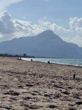 Campofelice di Roccella, a charming Sicilian seaside village in northern Sicily, Italy, featuring gentle Tyrrhenian Sea waves, golden sand, pebbles, and a peaceful Mediterranean coastal landscape.