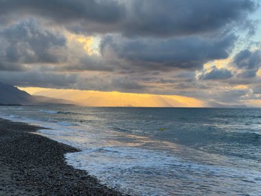 Campofelice di Roccella, a charming Sicilian seaside village in northern Sicily, Italy, featuring gentle Tyrrhenian Sea waves, golden sand, pebbles, and a peaceful Mediterranean coastal landscape.