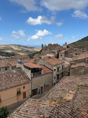 Collesano, a historic Sicilian mountain town in the Madonie Mountains, featuring narrow stone streets, traditional houses, and the Church of San Pietro, Sicily, Italy. Italian town in hills.