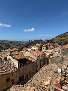 Collesano, a historic Sicilian mountain town in the Madonie Mountains, featuring narrow stone streets, traditional houses, and the Church of San Pietro, Sicily, Italy. Italian town in hills.