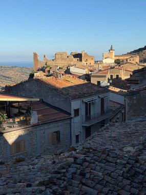 Collesano, a historic Sicilian mountain town in the Madonie Mountains, featuring narrow stone streets, traditional houses, and the Church of San Pietro, Sicily, Italy. Italian town in hills.