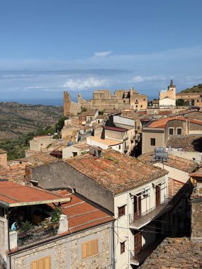 Collesano, a historic Sicilian mountain town in the Madonie Mountains, featuring narrow stone streets, traditional houses, and the Church of San Pietro, Sicily, Italy. Italian town in hills.