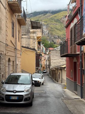 Collesano, a historic Sicilian mountain town in the Madonie Mountains, featuring narrow stone streets, traditional houses, and the Church of San Pietro, Sicily, Italy. Italian town in hills.