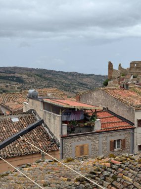 Collesano, a historic Sicilian mountain town in the Madonie Mountains, featuring narrow stone streets, traditional houses, and the Church of San Pietro, Sicily, Italy. Italian town in hills.