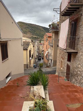 Collesano, a historic Sicilian mountain town in the Madonie Mountains, featuring narrow stone streets, traditional houses, and the Church of San Pietro, Sicily, Italy. Italian town in hills.
