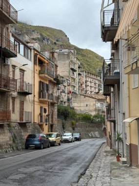 Collesano, a historic Sicilian mountain town in the Madonie Mountains, featuring narrow stone streets, traditional houses, and the Church of San Pietro, Sicily, Italy. Italian town in hills.
