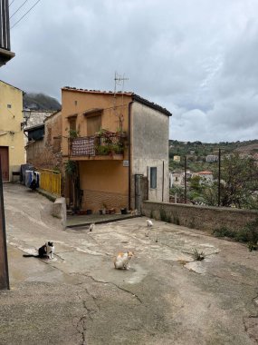Collesano, a historic Sicilian mountain town in the Madonie Mountains, featuring narrow stone streets, traditional houses, and the Church of San Pietro, Sicily, Italy. Italian town in hills.