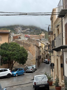 Collesano, a historic Sicilian mountain town in the Madonie Mountains, featuring narrow stone streets, traditional houses, and the Church of San Pietro, Sicily, Italy. Italian town in hills.