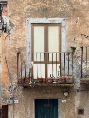 Collesano, a historic Sicilian mountain town in the Madonie Mountains, featuring narrow stone streets, traditional houses, and the Church of San Pietro, Sicily, Italy. Italian town in hills.