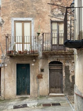 Collesano, a historic Sicilian mountain town in the Madonie Mountains, featuring narrow stone streets, traditional houses, and the Church of San Pietro, Sicily, Italy. Italian town in hills.