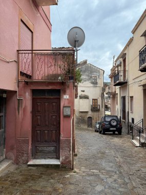 Collesano, a historic Sicilian mountain town in the Madonie Mountains, featuring narrow stone streets, traditional houses, and the Church of San Pietro, Sicily, Italy. Italian town in hills.